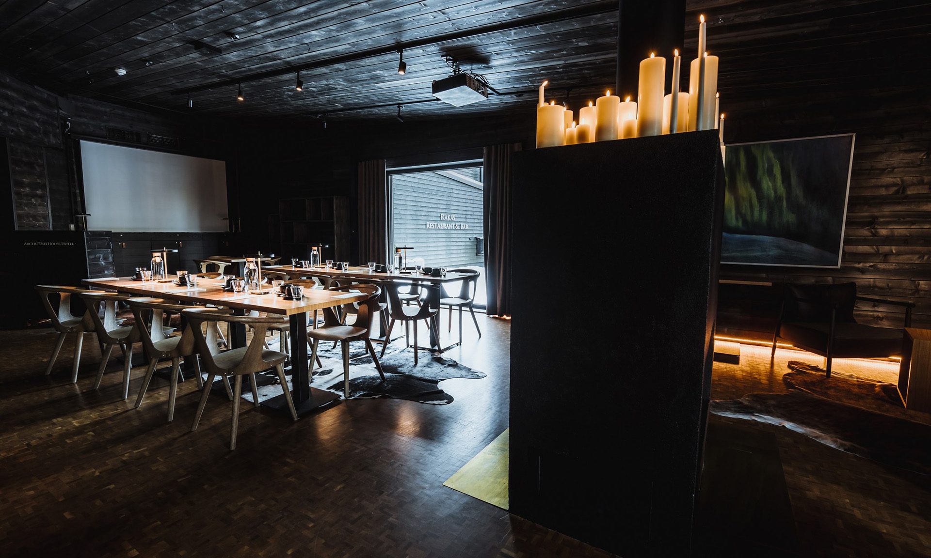 Salarakas meeting room with tables, chairs and fireplace.